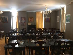 a dining room with tables and chairs and a chandelier at Art Hotel Athens in Athens