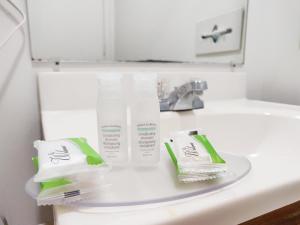 a bathroom sink with two toothbrushes and toothpaste at Countryside Inn Richmondville in Richmondville +24 photos
