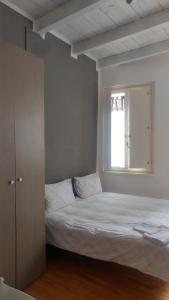 ein Schlafzimmer mit einem weißen Bett und einem Fenster in der Unterkunft Il Vecchio Portico in Cesena