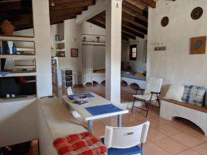 a living room with a table and a couch at Finca Sa Tafona in Son Servera