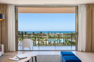 a living room with a view of the ocean at NAU Salgados Dunas Suites in Albufeira