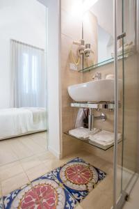 une salle de bain avec un lavabo et un miroir dans l'établissement La Finestra sul Convitto B&B, à Lecce