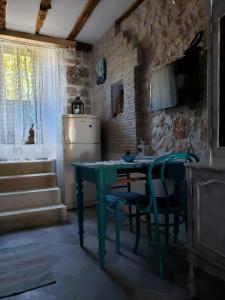 a kitchen with a green table and a refrigerator at Apartments Miki in Komiža