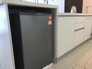 a refrigerator under a counter in a kitchen at CozyStudio Trefoil Setia Alam in Shah Alam