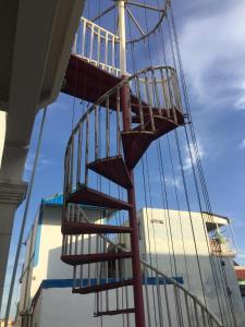 a wooden staircase in front of a building at Sweet Home in Phnom Penh