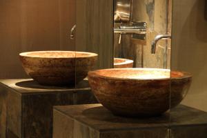 two brown bowls on a counter in a bathroom at Hotel Chiqui in Santander
