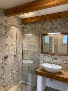 a bathroom with a sink and a shower at Casa La Margherita in Desenzano del Garda