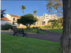 a park bench in front of a building at EM-Charming Apartment in Ponta Delgada