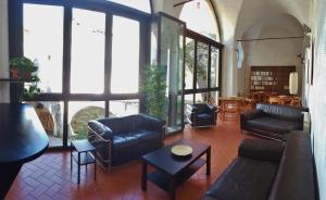 a living room with a couch and chairs and a table at Ospitalia del Mare Hostel in Levanto