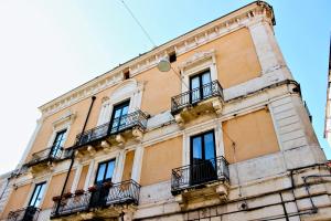a building with balconies on the side of it at B&B Terre di Catania in Catania