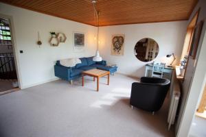 a living room with a blue couch and a table at 3 storey, 5 bedroom, 3 bathroom house in the center of Tórshavn in Tórshavn