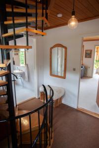 a room with a staircase and a mirror and a sink at 3 storey, 5 bedroom, 3 bathroom house in the center of Tórshavn in Tórshavn