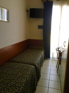 Posteľ alebo postele v izbe v ubytovaní Hotel Lido