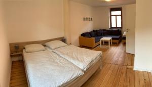 a bedroom with a bed and a living room with a couch at Ferienhaus Moritz in Pommern