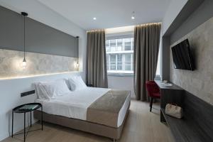 Postel nebo postele na pokoji v ubytování Philosofia Athens Suites
