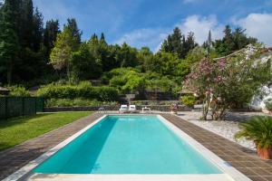 a swimming pool in the yard of a house at Corfu Town Mini Villa Private Pool Gardens in Mantoúkion