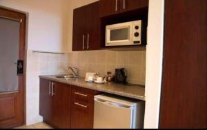 a small kitchen with a sink and a microwave at Ocean View Villas Unit A11 in Port Edward