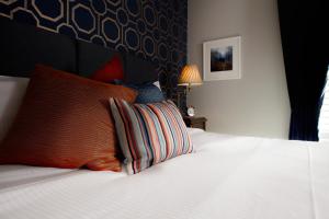 a bedroom with a white bed with two pillows at Moortown Lodge B&B in Ringwood