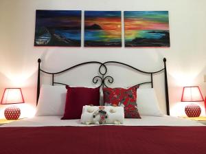 a bedroom with a bed with a teddy bear on it at Appartamenti Monacò in San Vito lo Capo