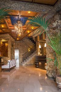 a lobby with stairs and a chandelier in a building at Nepheli Hotel in Kastrosikia