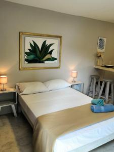 a bedroom with two beds and two tables and two lamps at Rentalife Playa in Playa del Carmen