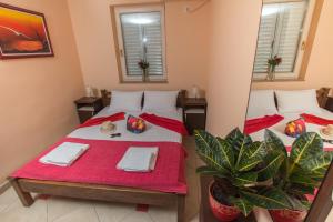 a room with two beds and a mirror at Adzic Apartments in Budva