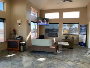 a waiting room with a couch and a tv at Best Western Desert Oasis in Ehrenberg