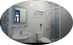 a bathroom with a sink and a toilet and a shower at Chang-an House B&B in Hualien City +16 photos