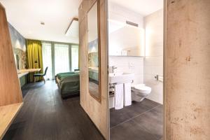 a bathroom with a sink and a toilet at Hotel sleep&stay - Self Check-in in Eglisau