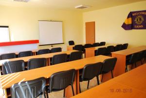 a classroom with tables and chairs and a whiteboard at Apart Hotel Central Razgrad in Razgrad +34 photos