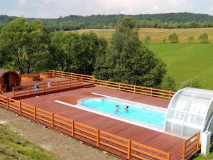 an overhead view of a large deck with a swimming pool at Edwardówka 601-130-636 - lipiec - sierpień - basen w cenie wynajmu domku in Polańczyk