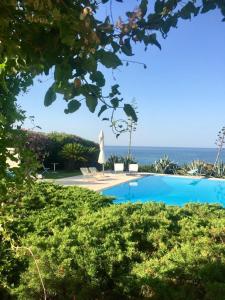 a swimming pool with the ocean in the background at Capitolo in Monopoli