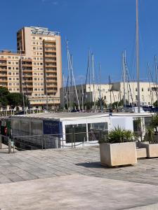 a boat parked in a marina with buildings in the background at Stella Marina Appartamento in Cagliari
