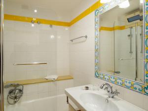 a bathroom with a sink and a mirror at Hotel Sirius in Taormina