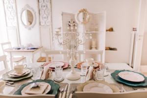 a dining room table with plates and dishes on it at RomAntic Dreams in Rome