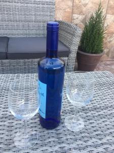 a bottle of wine sitting on a table with two wine glasses at La Terraza de Juana in Santa Cruz de la Palma