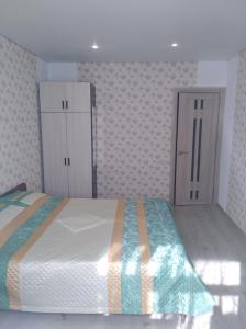 a bedroom with a bed and a cabinet in it at 2 комнатная квартира in Gagra