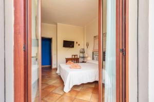 a bedroom with a white bed in a room at Il Leccio in Tortolì +31 photos