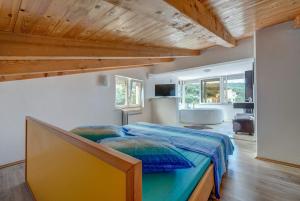 a bedroom with a large bed and a bathroom at Apartments Savar - Ilo in Brbinj