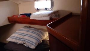 a small room with a bed and a pillow at Velero MissTick,Gibsea 47'2 in Puerto Calero