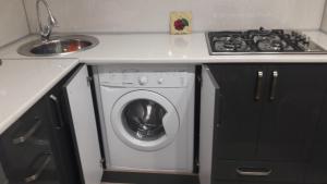 a kitchen with a washing machine and a sink at E-Home Batumi in Batumi +21 photos