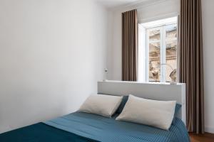 Postel nebo postele na pokoji v ubytování D-Home Ortigia