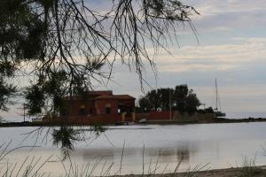 a house on the shore of a body of water at Hotel Celeste in Marzamemi