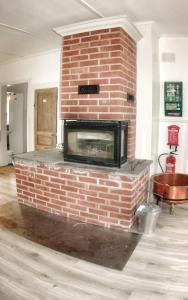 a red brick fireplace in a living room at Lundsbrunn B&B in Lundsbrunn
