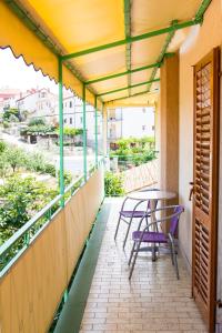 a balcony with a table and chairs on it at Green garden apartments in Rovinj