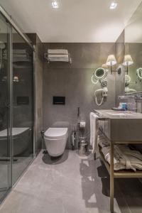 a bathroom with a toilet and a sink and a tub at Galata Times Hotel in Istanbul