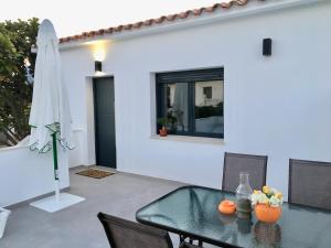 a dining room with a glass table and chairs at Mediterranea Suite Apartment in Albir