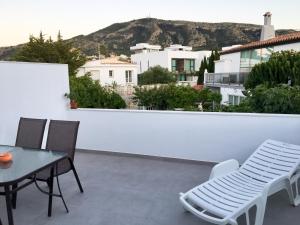 a patio with a table and chairs on a balcony at Mediterranea Suite Apartment in Albir