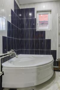 a bathroom with a white toilet and a window at Apartment Mihajlovic in Vranje