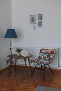 Zimmer mit einem Tisch, einem Stuhl und einer Lampe in der Unterkunft Apartment Mihajlovic in Vranje